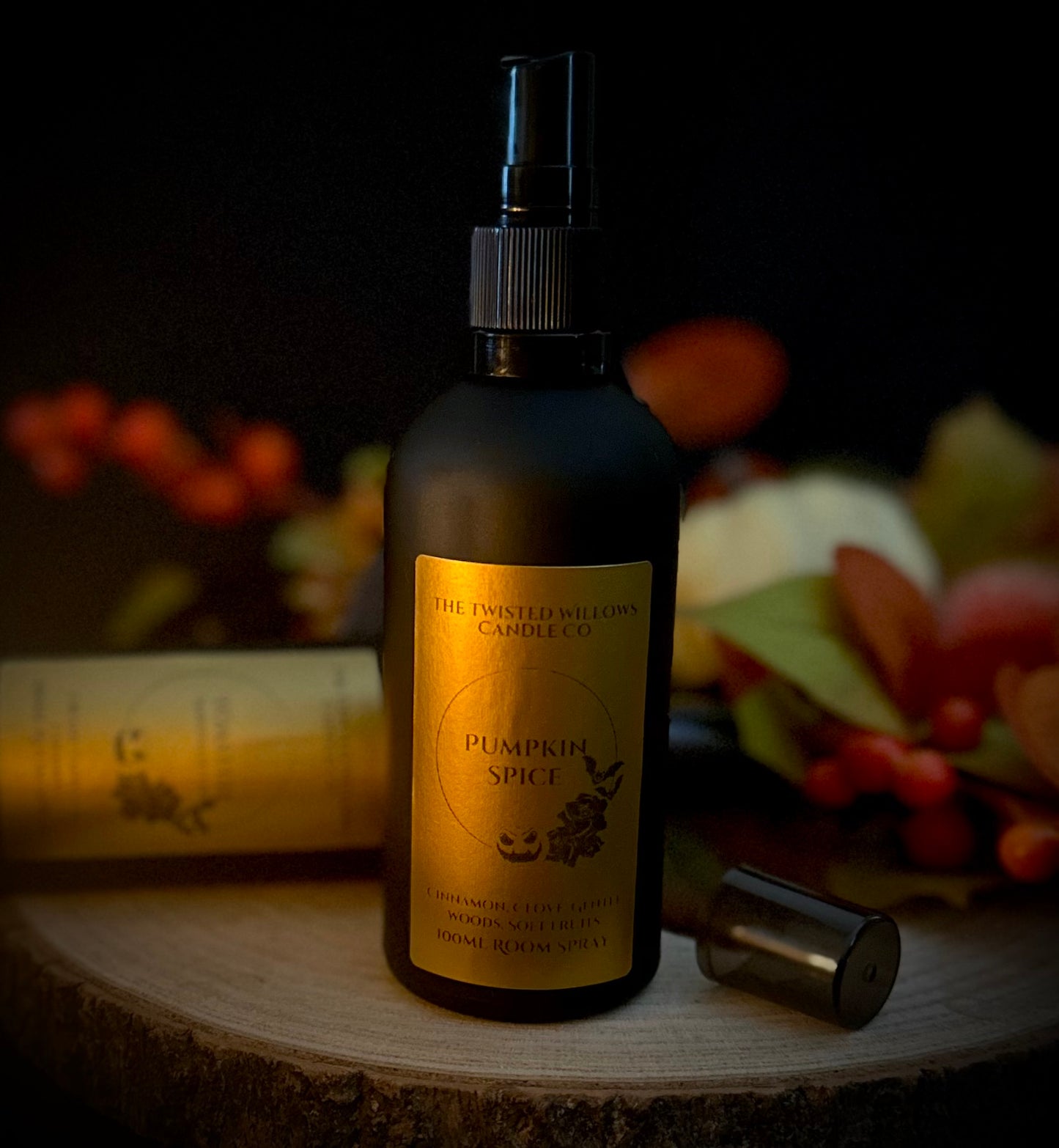 Close up of a matte black perfume bottle with Pumpkin Spice Label