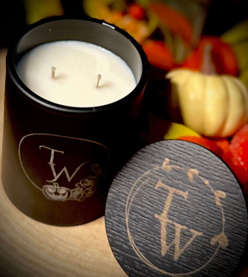 black etched candle jar, showing its scale and beautiful design with etched wooden lid.