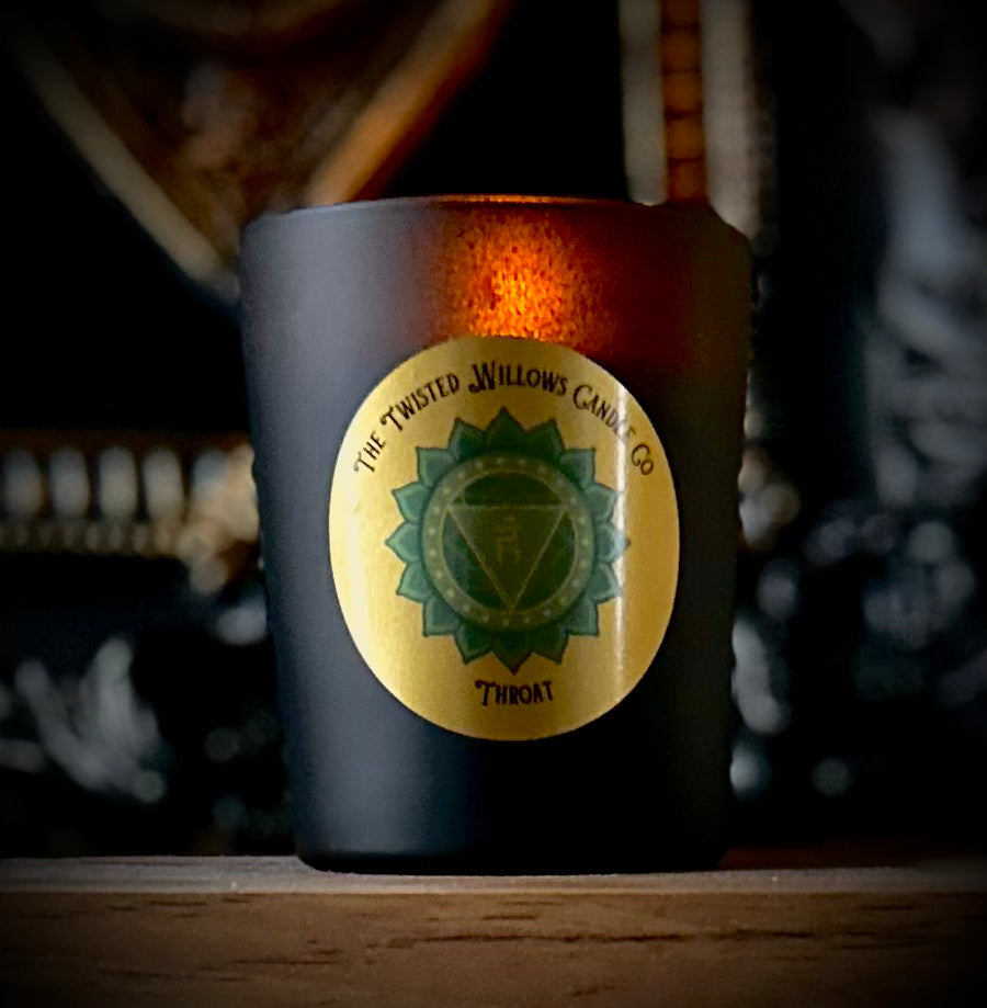 Voice liberation ritual with throat chakra candle, cypress and spearmint oils awakening honest expression.
