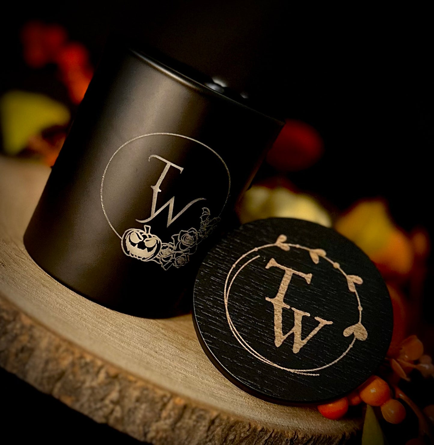 The black candle jar styled without lid and with autumn foliage.