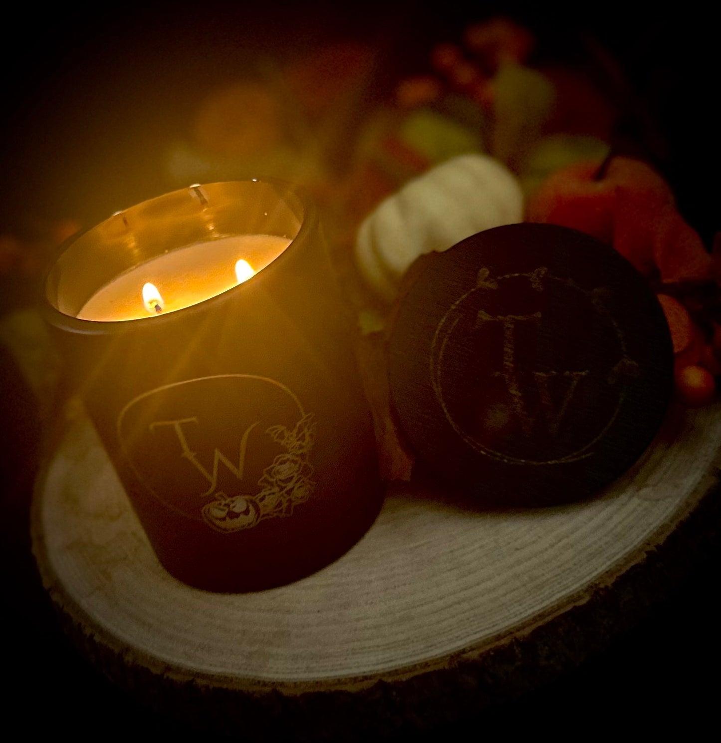 Gothic toasted marshmallow candle burning with two steady flames, creating a cozy ambiance.