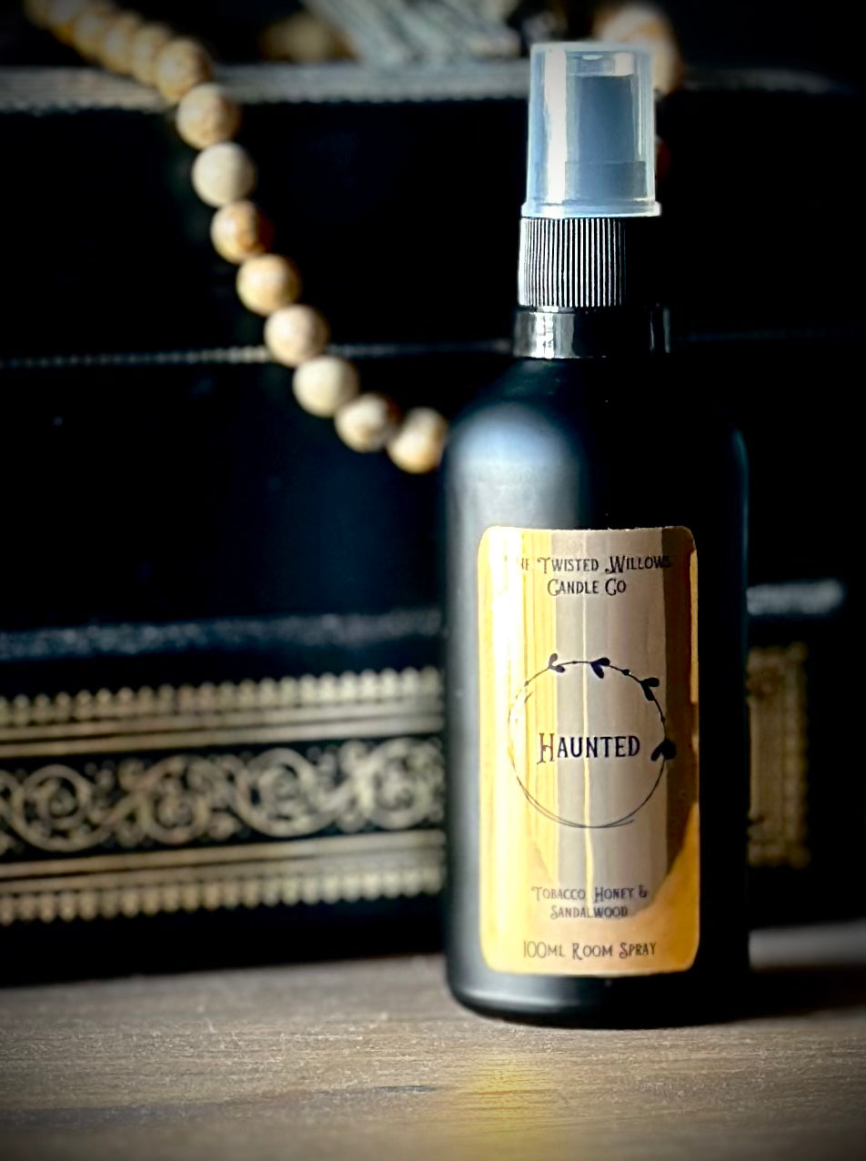 Haunted Gothic Room Spray in matte black glass bottle with gold label, scented with dark honey, tobacco and sandalwood.