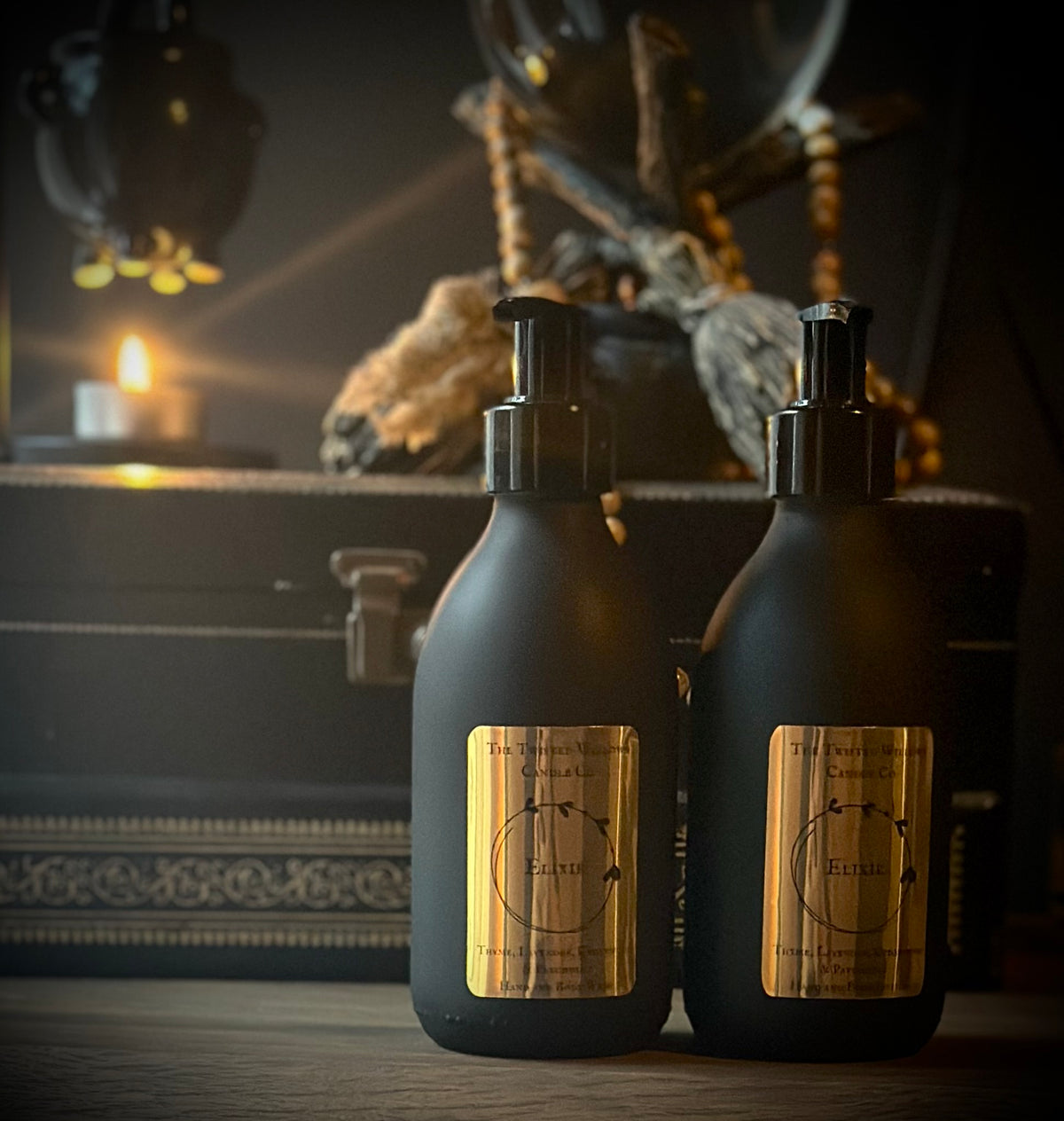 Elixir Hand and Body Wash and Lotion in Matte black glass jars.