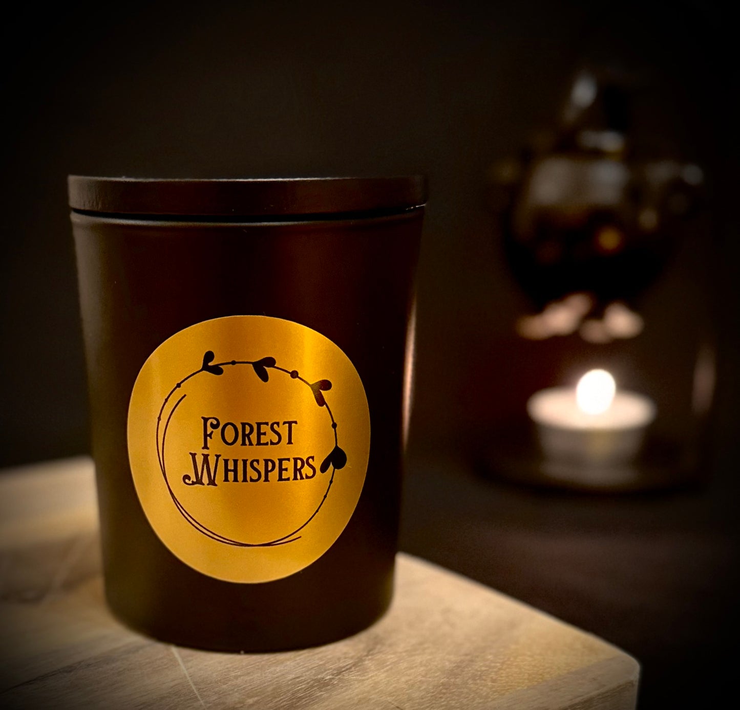 Forest Whispers candle in matte black jar with classy gold label
