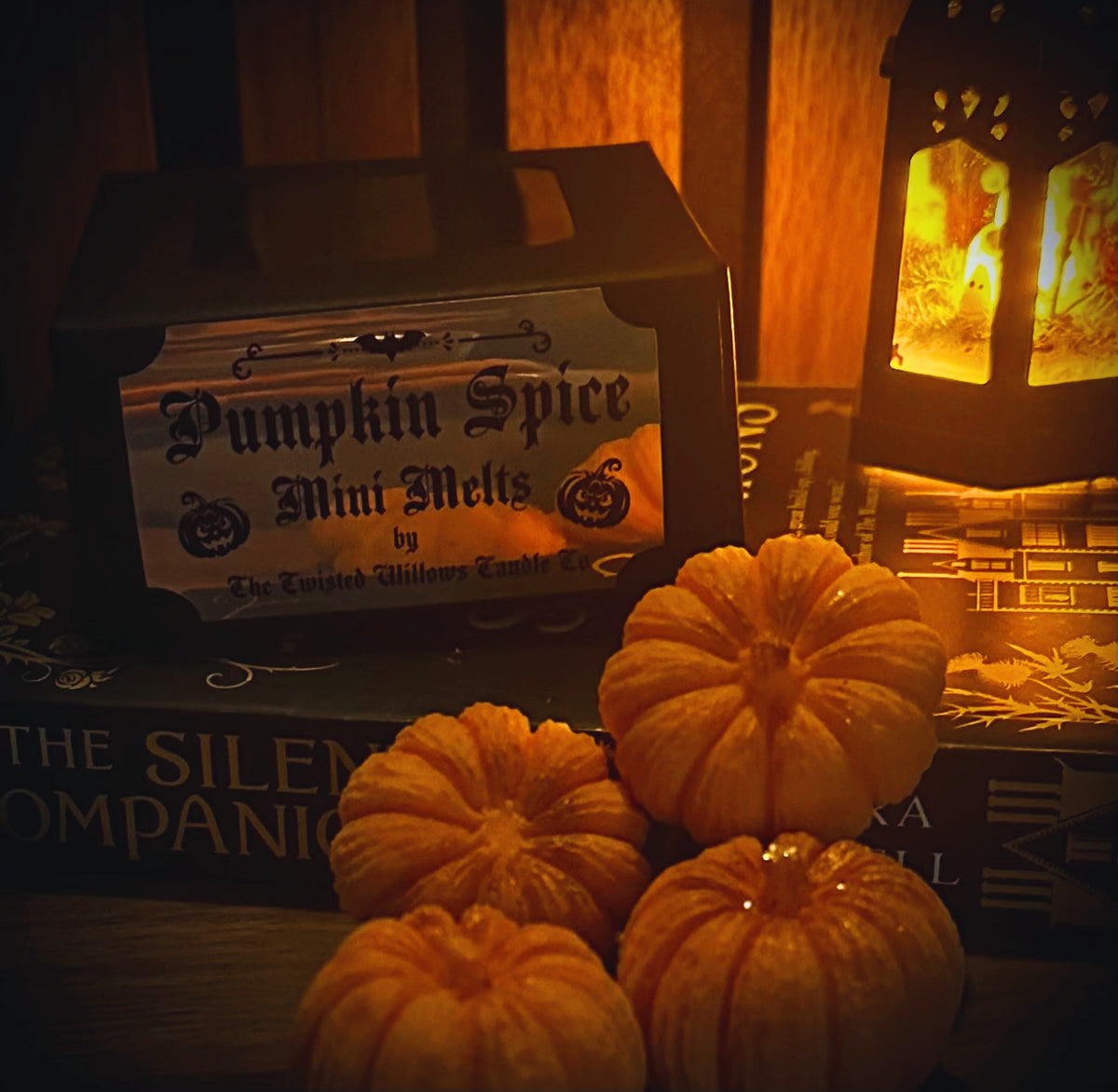 Mini pumpkin-shaped wax melts in a warm autumn setting