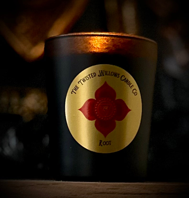 Eco-friendly Root Chakra votive candle in minimalist black jar made with pure essential oils for stability and calm.