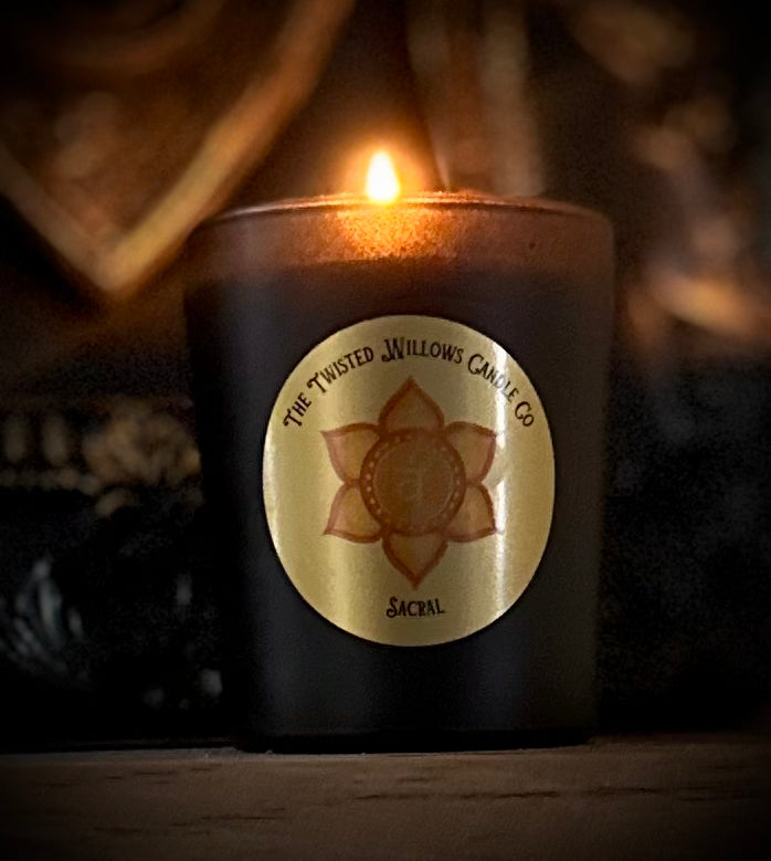 Soy wax votive emitting warm mandarin and patchouli scent for passion and creative awakening.