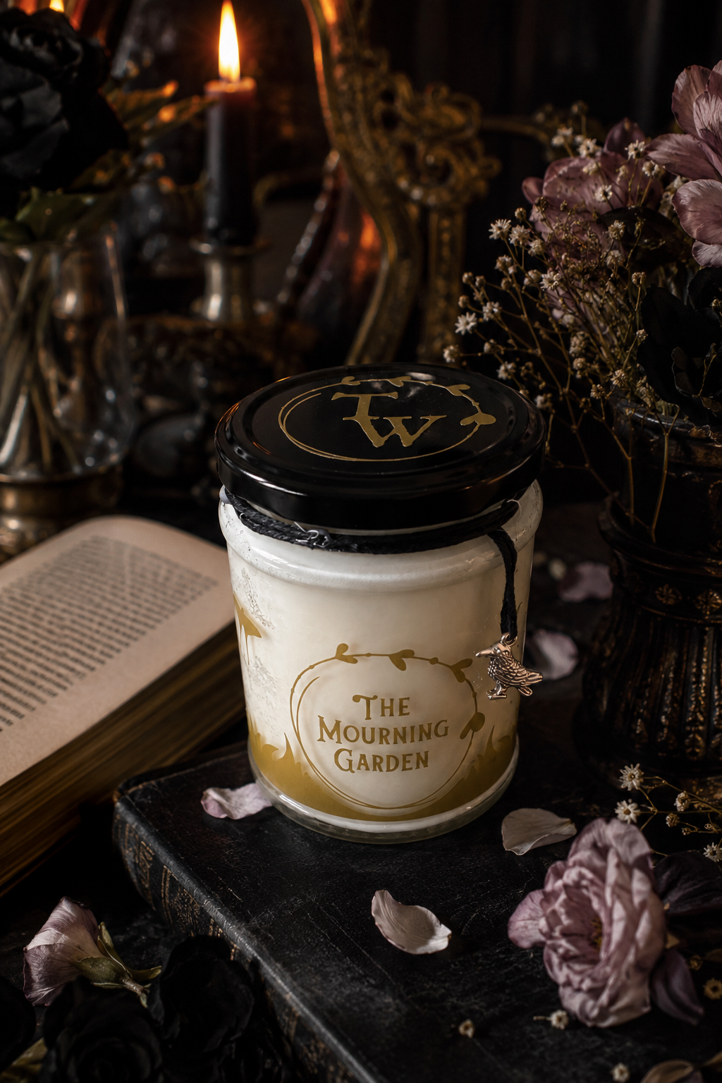 The Mourning Garden limited edition gothic floral soy candle in a clear glass jar with gold gothic garden design.