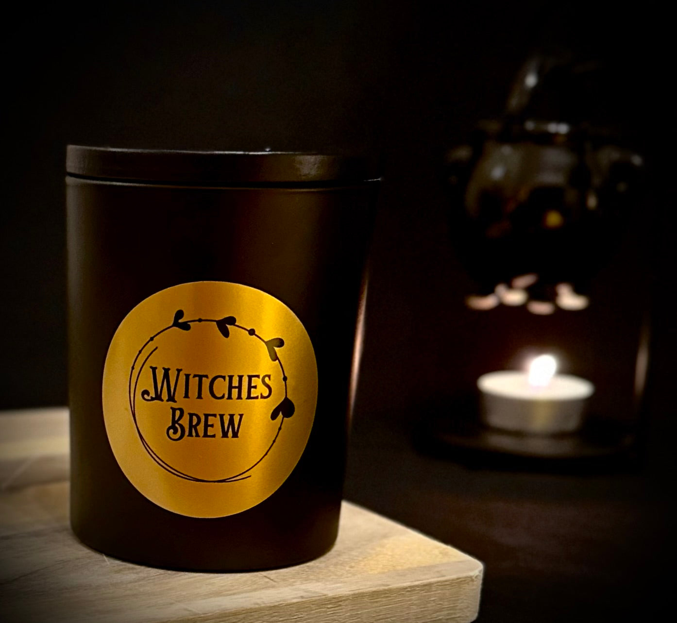 Witches Brew Candle in matte black jar with a classy gold label
