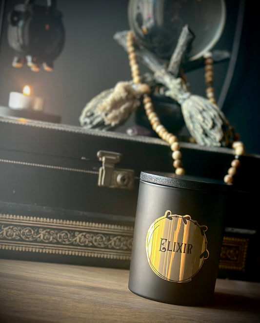Elixir gothic jar candle in matt black glass with metallic gold label, scented with thyme, lavender, patchouli and cedarwood