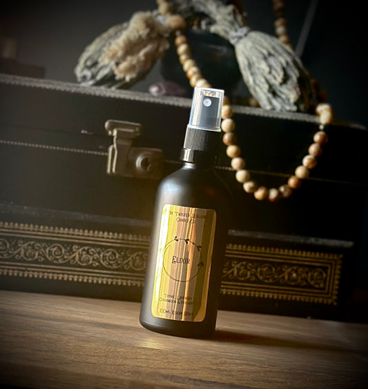 Elixir gothic room spray in matt black glass bottle with metallic gold label, thyme lavender patchouli and cedarwood